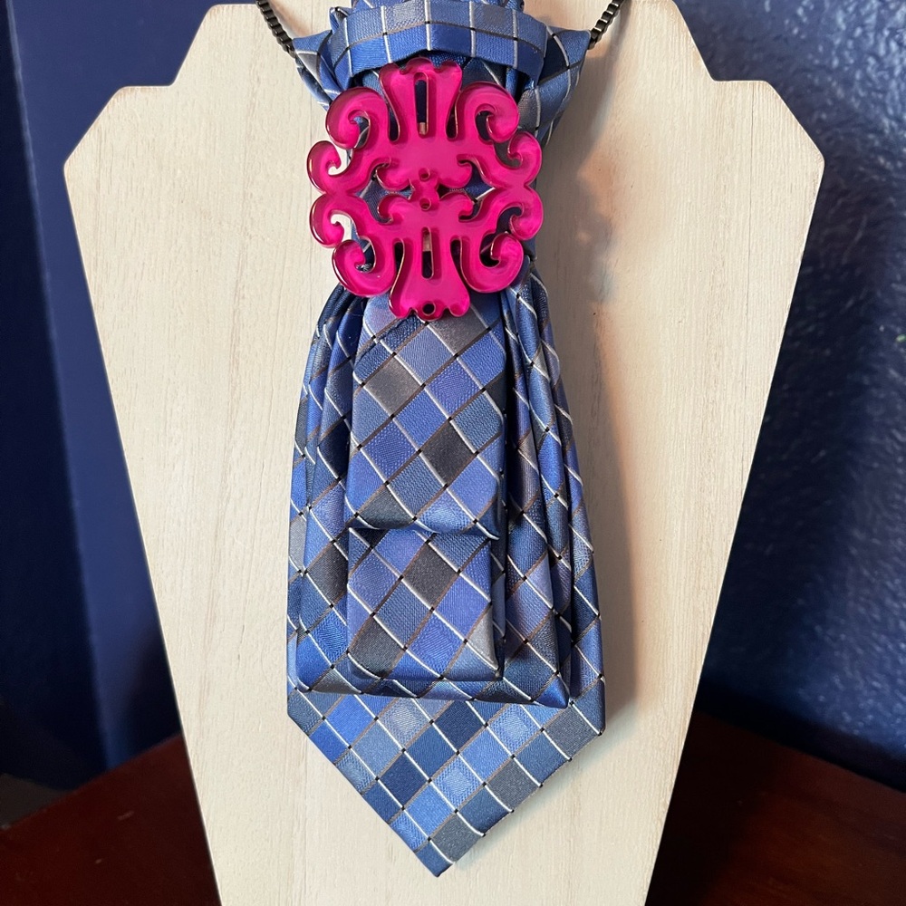 TIE NECKLACE with blue, black, pink and gray accents.
